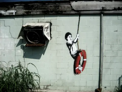 Banksy boy swing life preserver new orleans