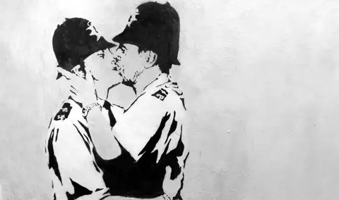Banksy kissing coppers