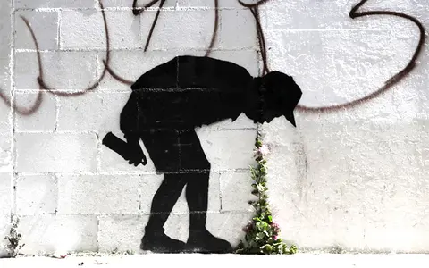 Stencil man vomiting flowers street art